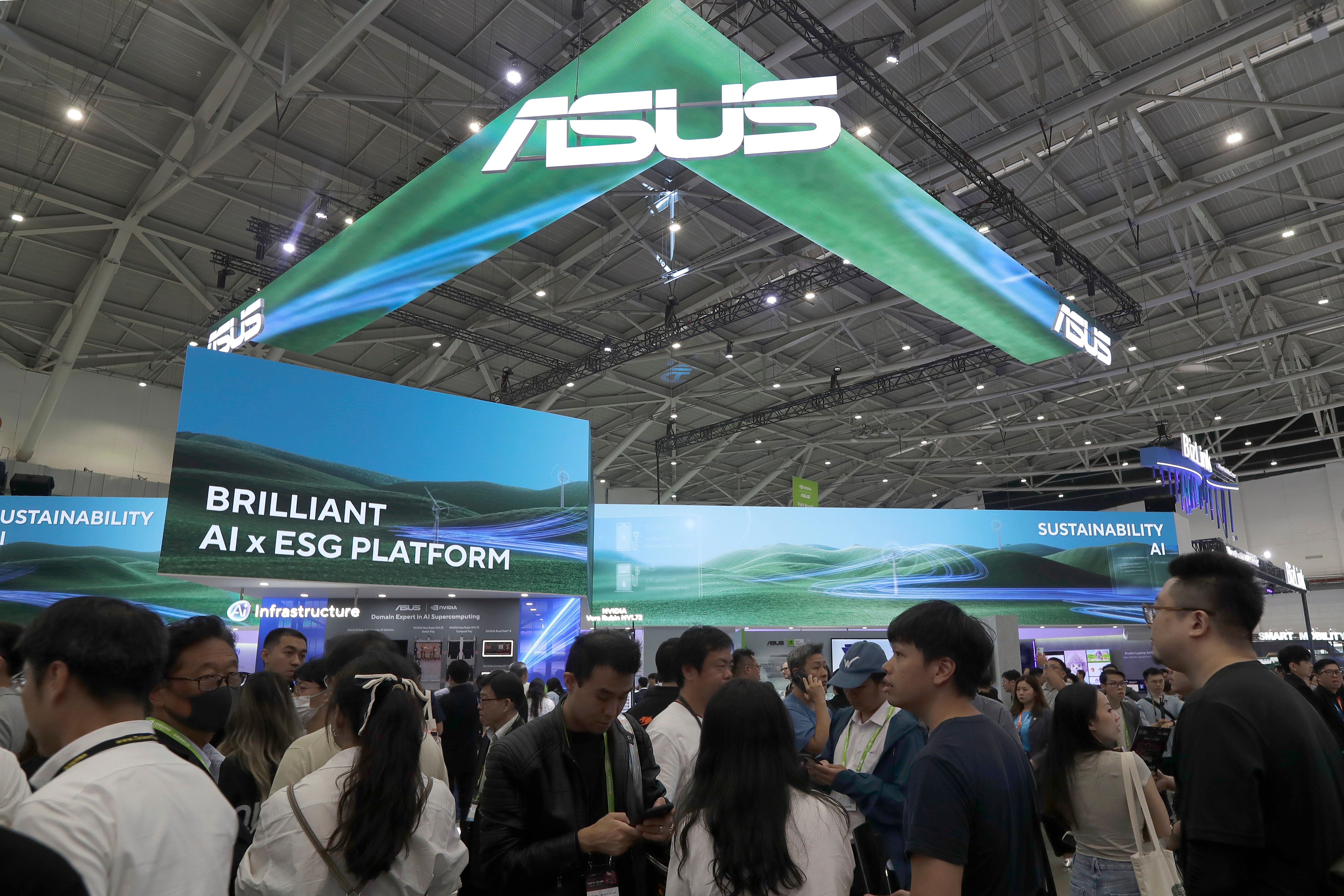 Visitors walk by the Asus booth at the Computex Taipei exhibition, one of the world's largest computer and technology expos, in Taipei, Taiwan, Tuesday, June 2, 2026. (AP Photo/Chiang Ying-ying)